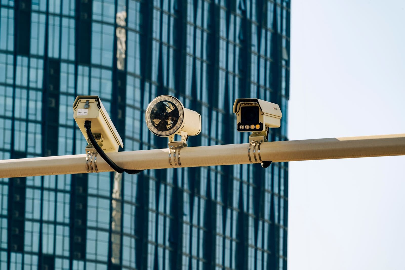 Outdoor surveillance camera array mounted against a glass office building