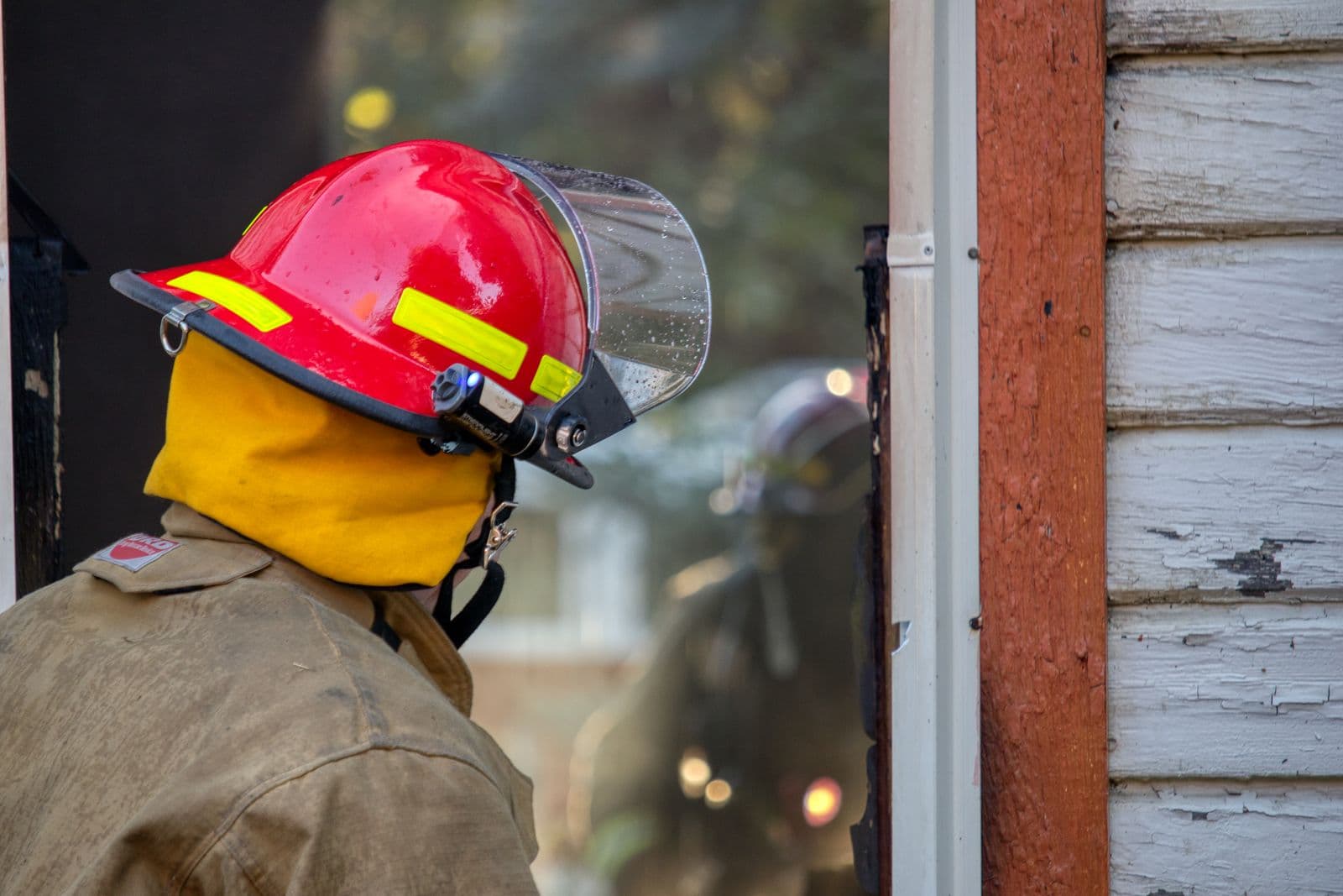 Firefighter assessing conditions from a building entrance